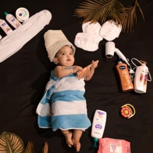 Adorable baby wrapped in towel with skincare essentials. Perfect for beauty and childcare themes.